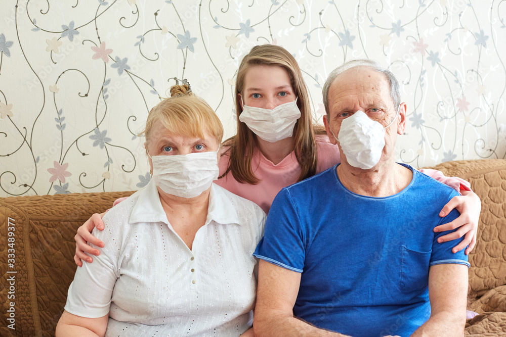 granddaughter with grandparents in medical masks, individual protection against viruses and diseases