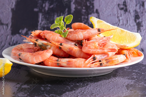 Fresh organic boiled shrimps with oregano twig macro view. Sea food background.