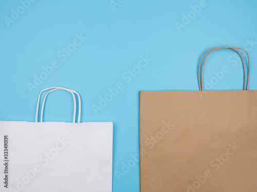 Paper bags with handles on a blue background.