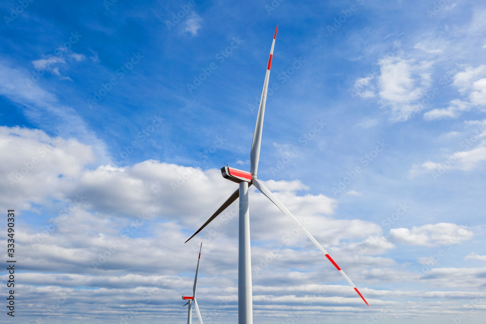 two wind wheels in an bright cloudscape two wind wheels in an bright cloudscape