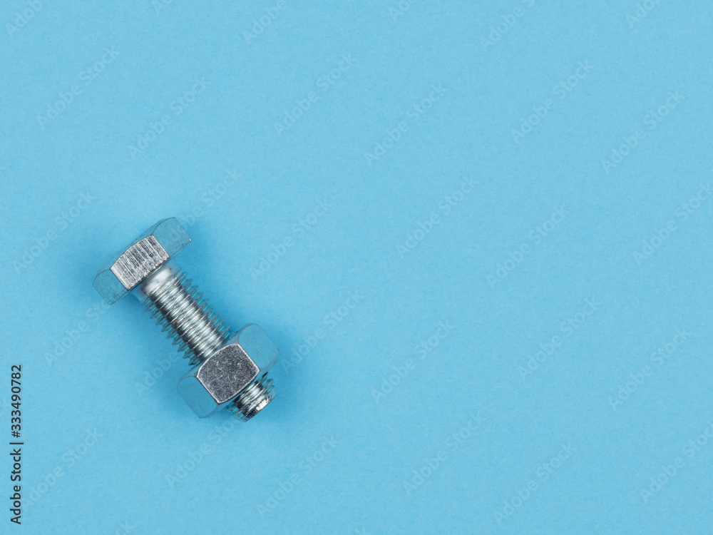 Nut, twist the bolt on a blue background.