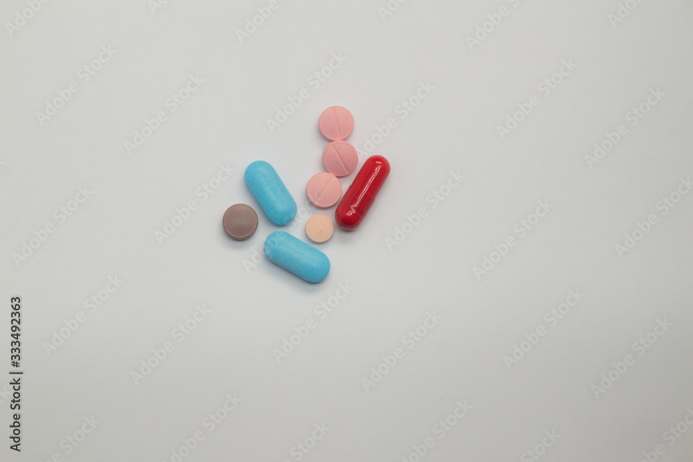 Colored pills on white background Legal drugs in the form of tablets. Medicines for use in humans. Colored pills on white background Legal drugs in the form of tablets. Medicines for use in humans.