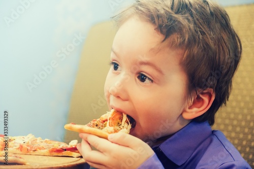 Hungry child eat slice pizza,  fast.Hungry child eat slice pizza,  fast.