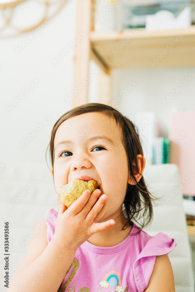 Toddler Girl Eating Banana Muffin Toddler Girl Eating Banana Muffin