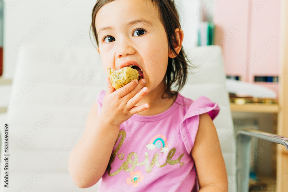 Toddler Girl Eating Banana Muffin Toddler Girl Eating Banana Muffin