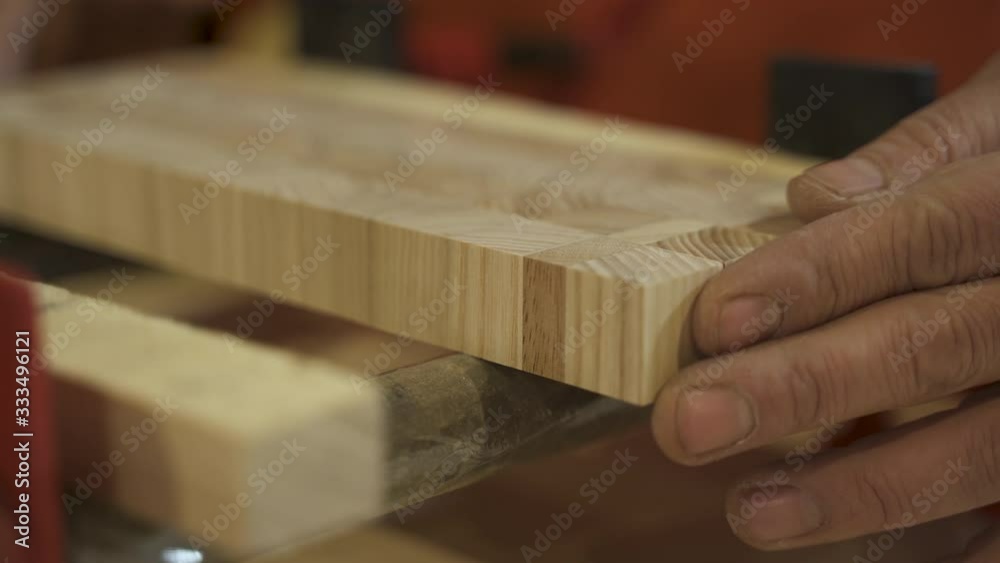 Carpenter sorting wooden boards Carpenter sorting wooden boards