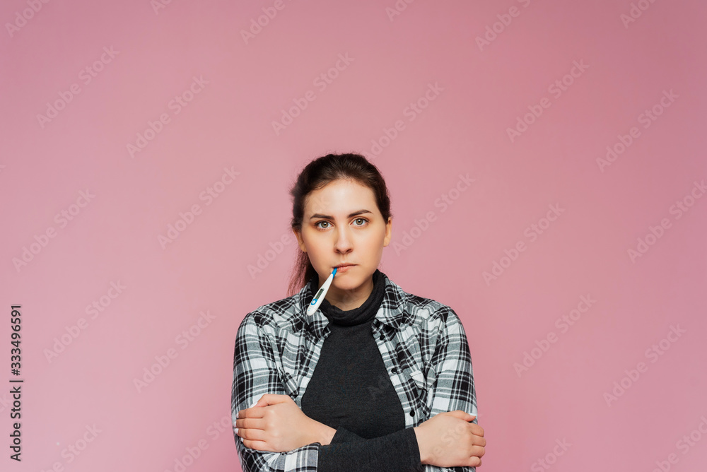 Young teenager afraid of getting coronavirus. Prevention of the Chinese virus. The woman frowned and fears infection and a global pandemic Young teenager afraid of getting coronavirus. Prevention of the Chinese virus. The woman frowned and fears infection and a global pandemic