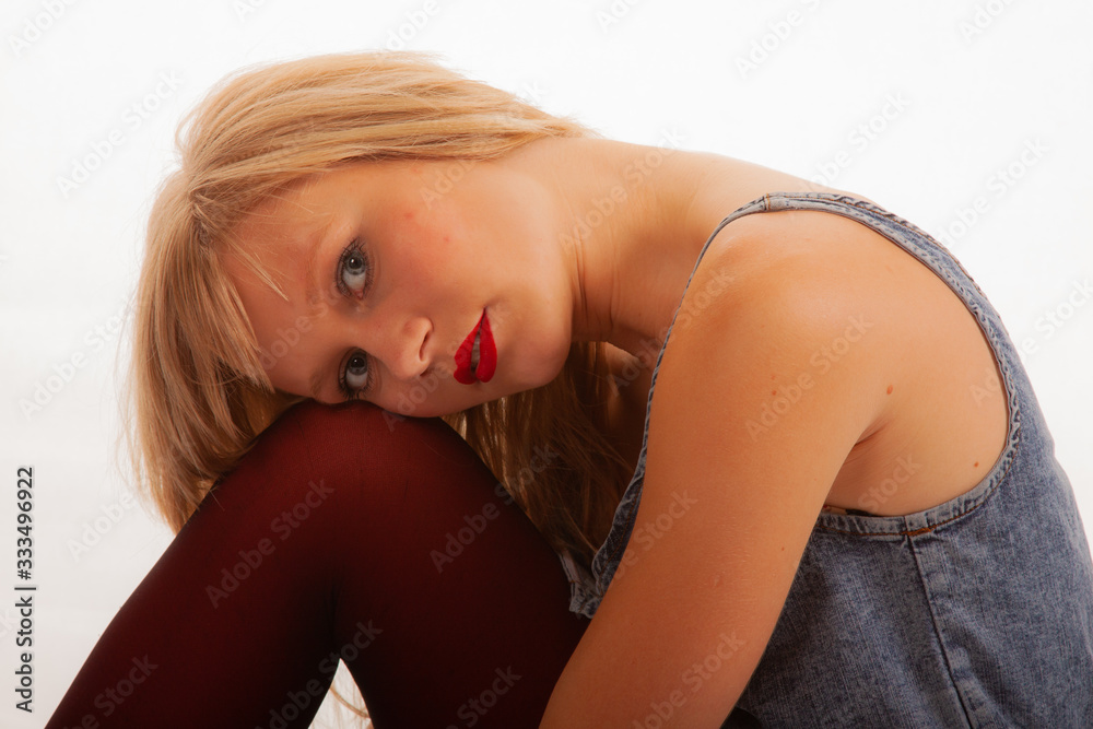 Pretty young blonde girl against a white background Pretty young blonde girl against a white background