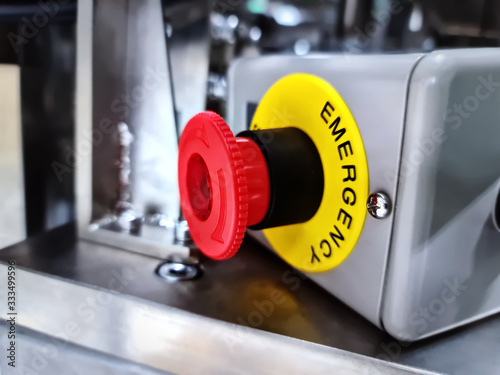 Close-up Emergency Button Against Blurred Machine Background