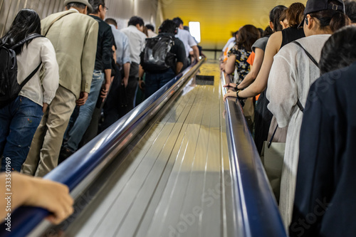 Photography People riding an escalator inside the subway system of Tokyo
