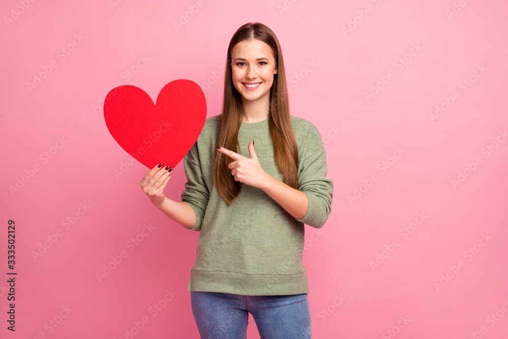 Positive cheerful girl point index finger big red paper card heart she get her boyfriend 14-february date celebration wear casual style stylish trend jumper isolated pastel color background Positive cheerful girl point index finger big red paper card heart she get her boyfriend 14-february date celebration wear casual style stylish trend jumper isolated pastel color background