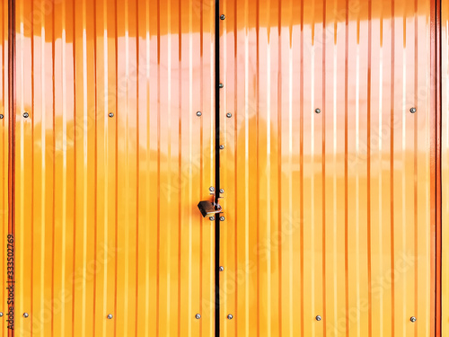Full Frame Background of Locked Corrugated Yellow Shutter Door
