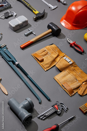 Konstfotografi high angle view of tool belt, hammers, monkey wrench, putty knife, pliers, helme