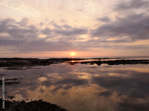 Sunset reflected in still sea