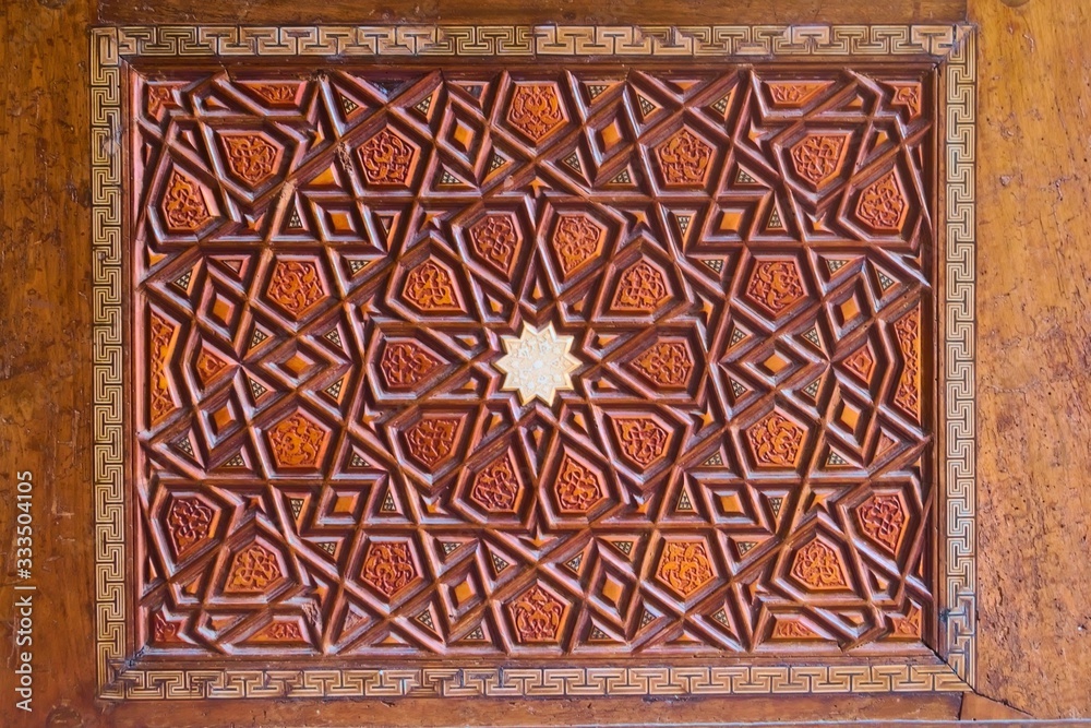 Geometrical pattern on a wooden door at a the Sehzade Mosque in Istanbul, Turkey. Islamic art, woodwork, detail close up.