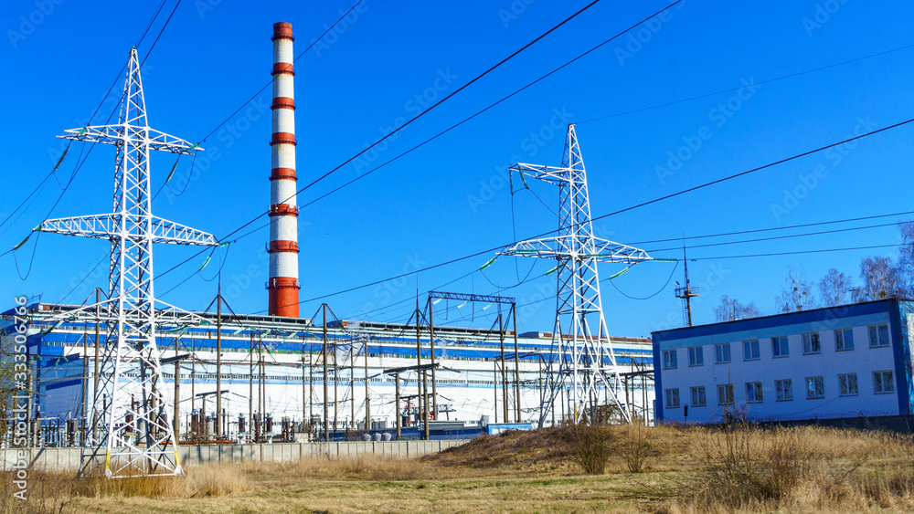 Thermal power station, electric wires and poles on classic blue sky background. Green power and ecological problem. Thermal power station, electric wires and poles on classic blue sky background. Green power and ecological problem.