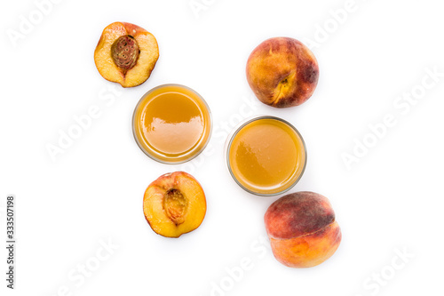 Natural peach juice in glass isolated on white background. Top view