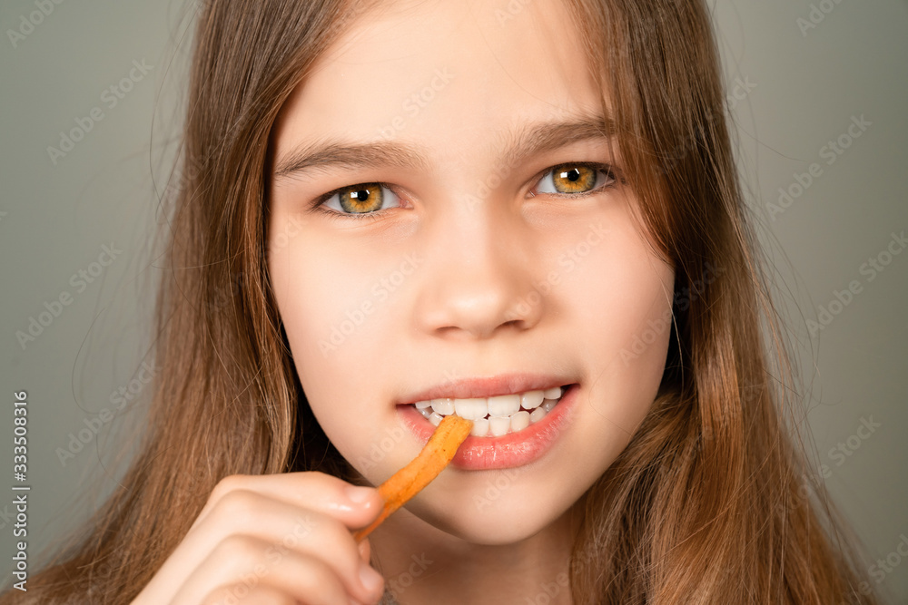 teenage girl eating French fries closeup. teenage girl eating French fries closeup.