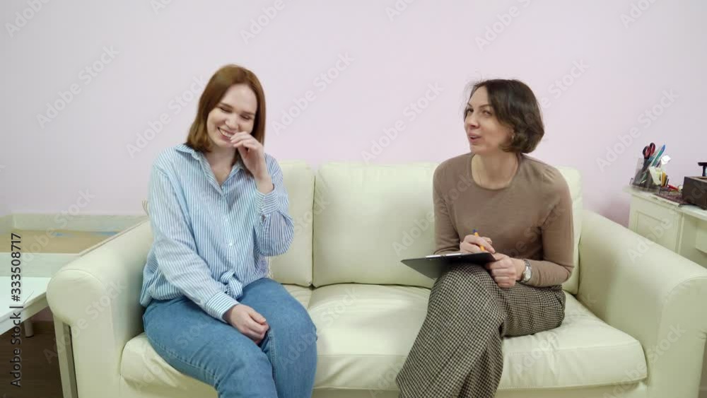 woman laughs in psychologist office for counseling woman laughs in psychologist office for counseling
