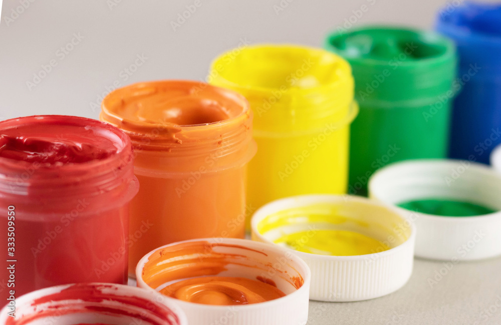 Colorful vibrant cans of gouache isolated on white Colorful vibrant cans of gouache isolated on white