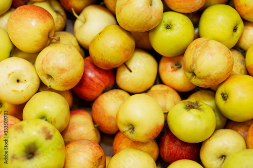 Juicy apples on a store counter. Vegetarianism and raw food diet. Close-up. View from above.