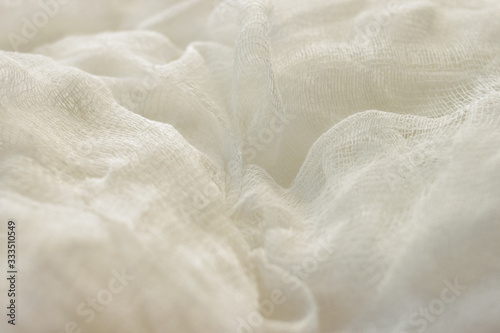 white color woven cotton gauze fabric background texture. close up top view.