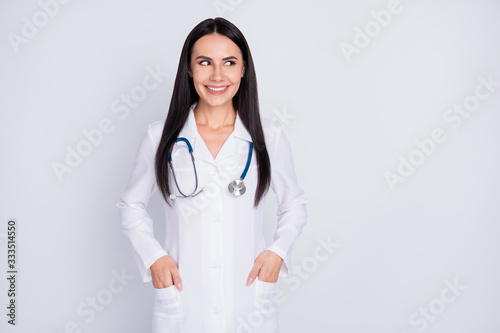 Photo of attractive friendly doctor lady consultation rehabilitation center professional look empty space wear white long lab coat stethoscope isolated grey color background