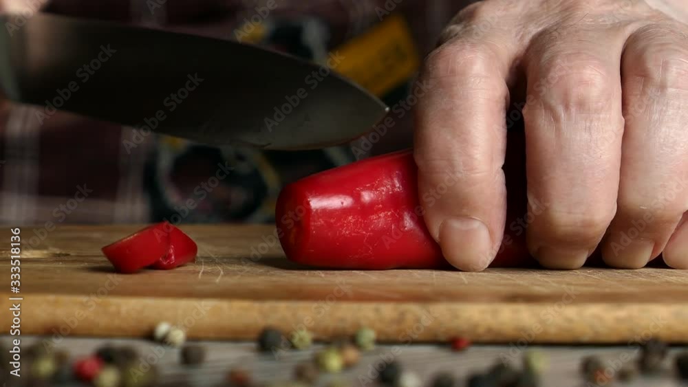 Using Knife To Cutting Ramiro Red Hot Pepper On Cutting Wooden Board. Top View. Panning Slider Shot. Close Up.. Using Knife To Cutting Ramiro Red Hot Pepper On Cutting Wooden Board. Top View. Panning Slider Shot. Close Up..
