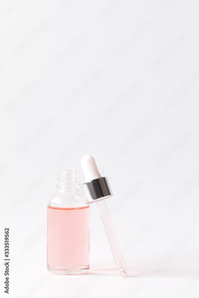 Dropper Bottle with a pipette and pink water.Organic SPA cosmetics .Mock-Up. Dropper Bottle with a pipette and pink water.Organic SPA cosmetics .Mock-Up.