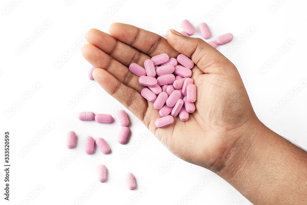 pills or caplet on human hand