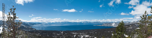Lake Tahoe panorama with snow on the ground and view on peaks of Sierra Nevada mountains
