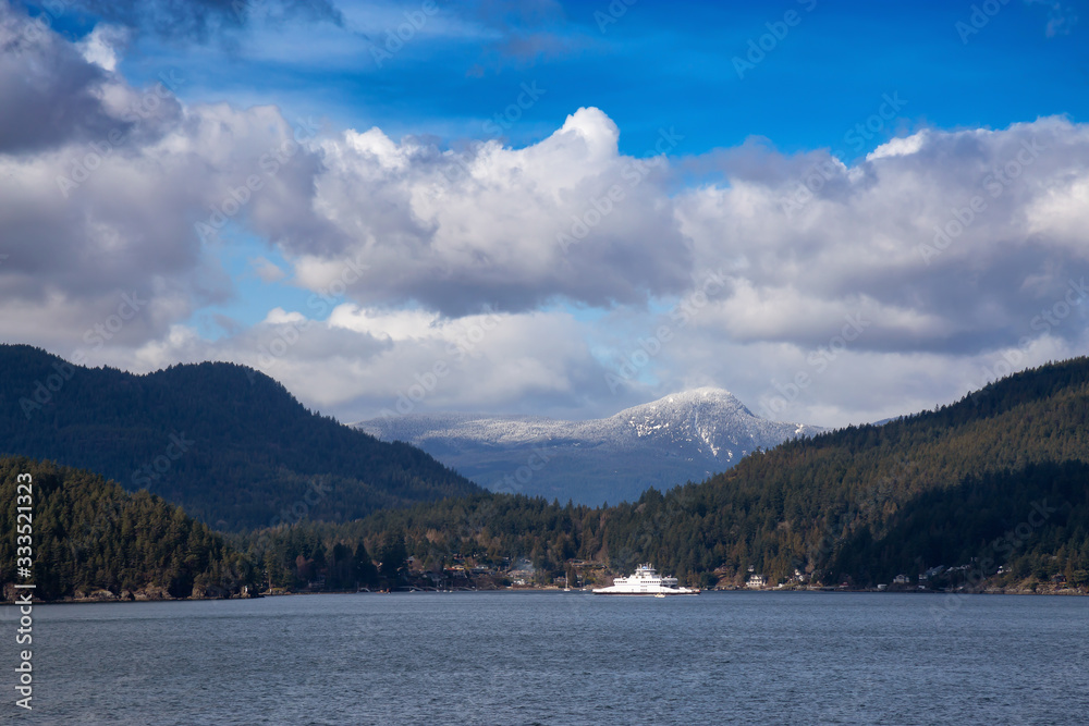 View of Bowen Island during a sunny winter day with Ferry Leaving the Terminal. Taken at Horseshoe Bay, West Vancouver, British Columbia, Canada. Nature Background