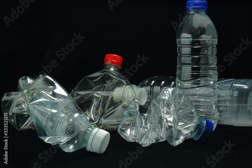 A color image of single use plastic bottles that need to be recycled.