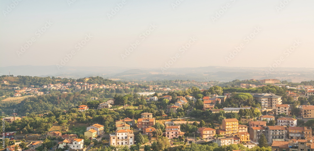 Small town with tiled roofs on  hillside in Italy