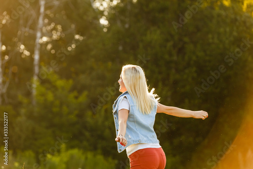 beautiful young blond woman alone in the park