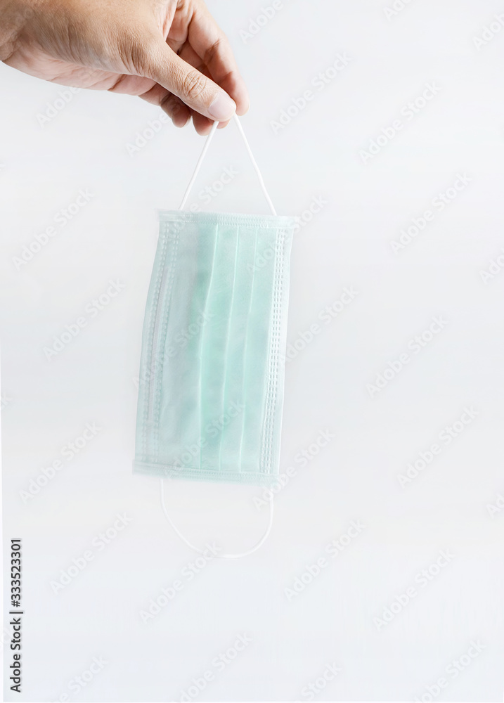 Hand holding surgical mask or mask face,for coronavirus, sanitizer concept, covid 19 Hand holding surgical mask or mask face,for coronavirus, sanitizer concept, covid 19