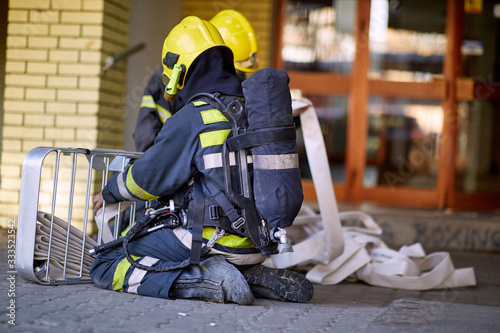 Fireman in uniform in front of fire truck going to rescue and protect. Emergancy servise concept. photo