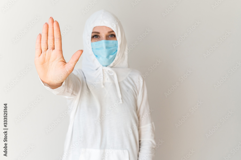 Woman in a protective suit and a medical mask Woman in a protective suit and a medical mask