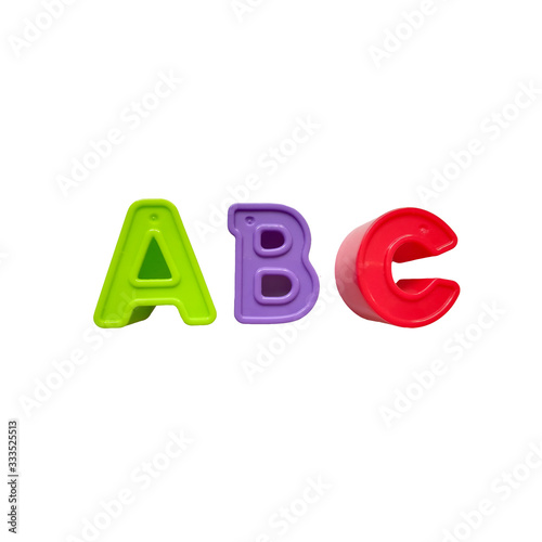 multi-colored plastic letters a, b, c are isolated on a white background. green, purple, red, toys, alphabet learning