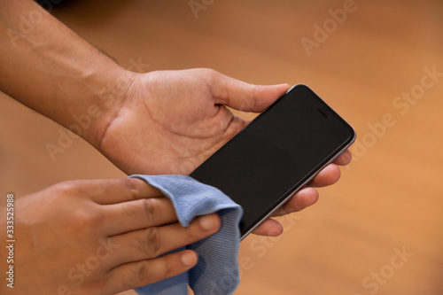 limpando o celular para evitar coronavírus - Cleaning the cell phone to prevent coronavirus photo