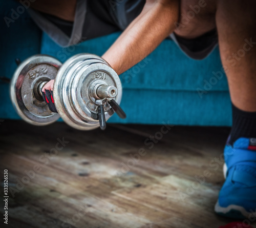 Close up of a man working out with a dumbbell