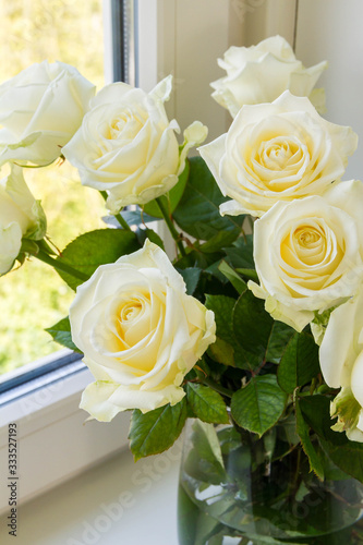 White roses in glass vase.