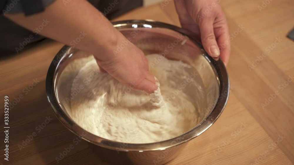 Hands mixing dough on table