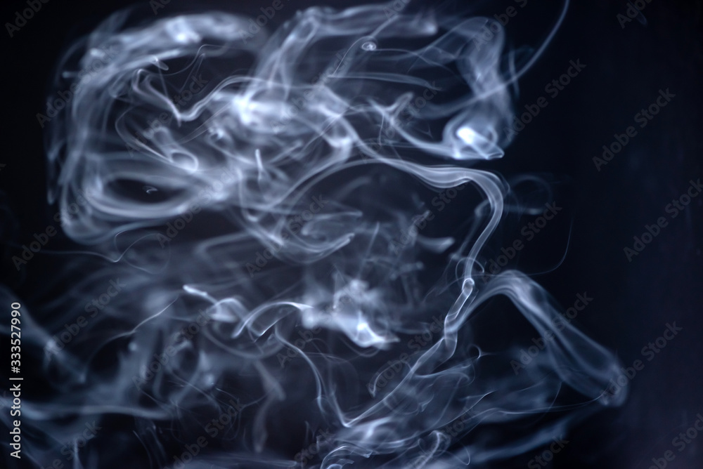 Incense smoke with many curves on dark background Incense smoke with many curves on dark background
