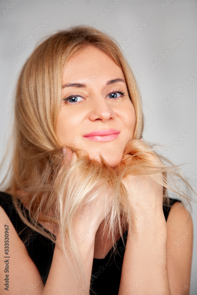 pretty young blonde woman on background. portrait closeup pretty young blonde woman on background. portrait closeup