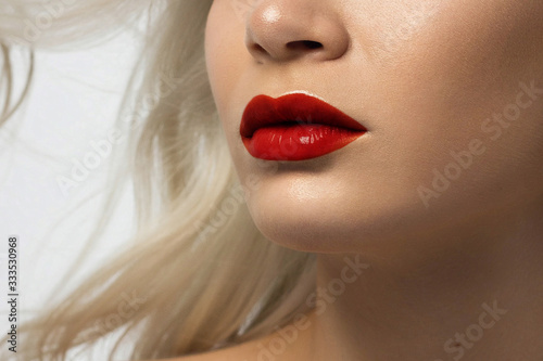 Sexual full lips. Natural gloss of lips and woman's skin. The mouth is closed. Increase in lips, cosmetology. red lipstick. Open mouth and with teeth. blonde hair.