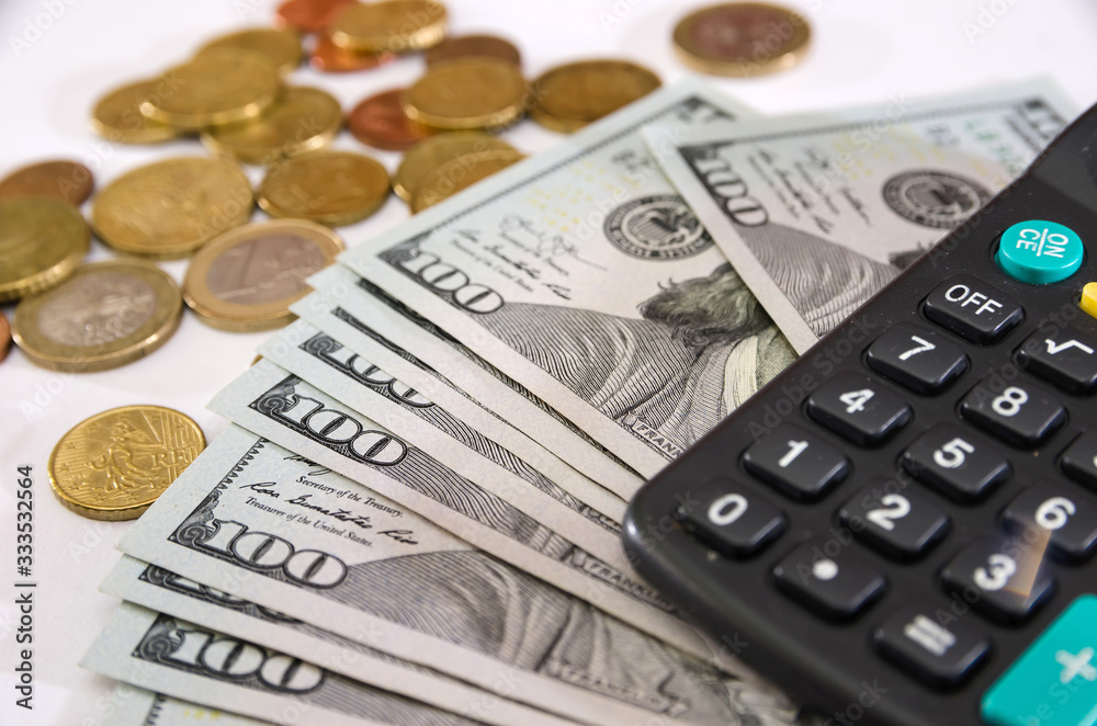 calculator, dollars and coins on white. calculator, dollars and coins on white.