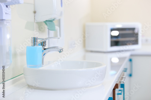 The Washbasin and sanitizer in the dentist's office