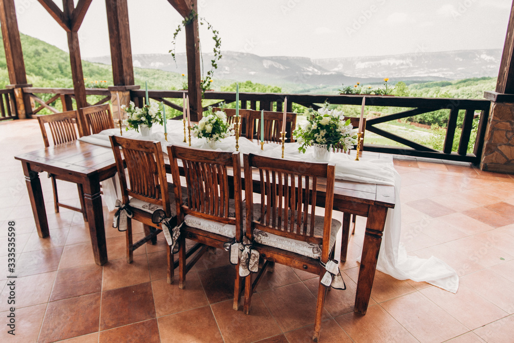 Decorated wedding table for the newlyweds and guests with mountain views. Wedding decor and Floristics.
