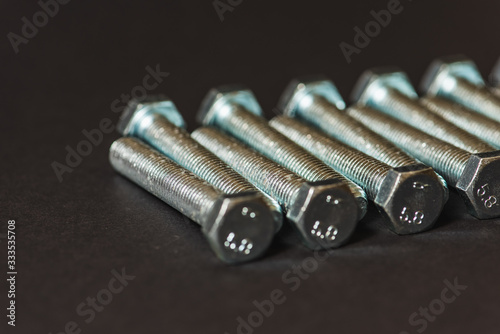 metal bolts isolated on dark background 
